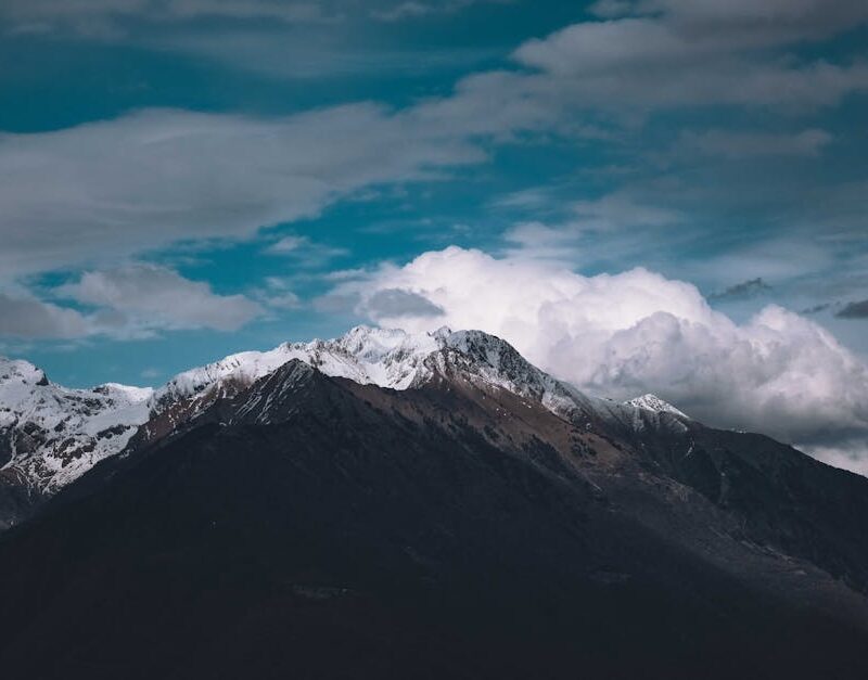 Mountain Landscapes - Picturesque view of high mountain slopes covered #7898338